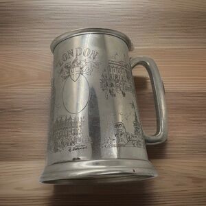 This is a vintage English pewter tankard or mug featuring engraved London